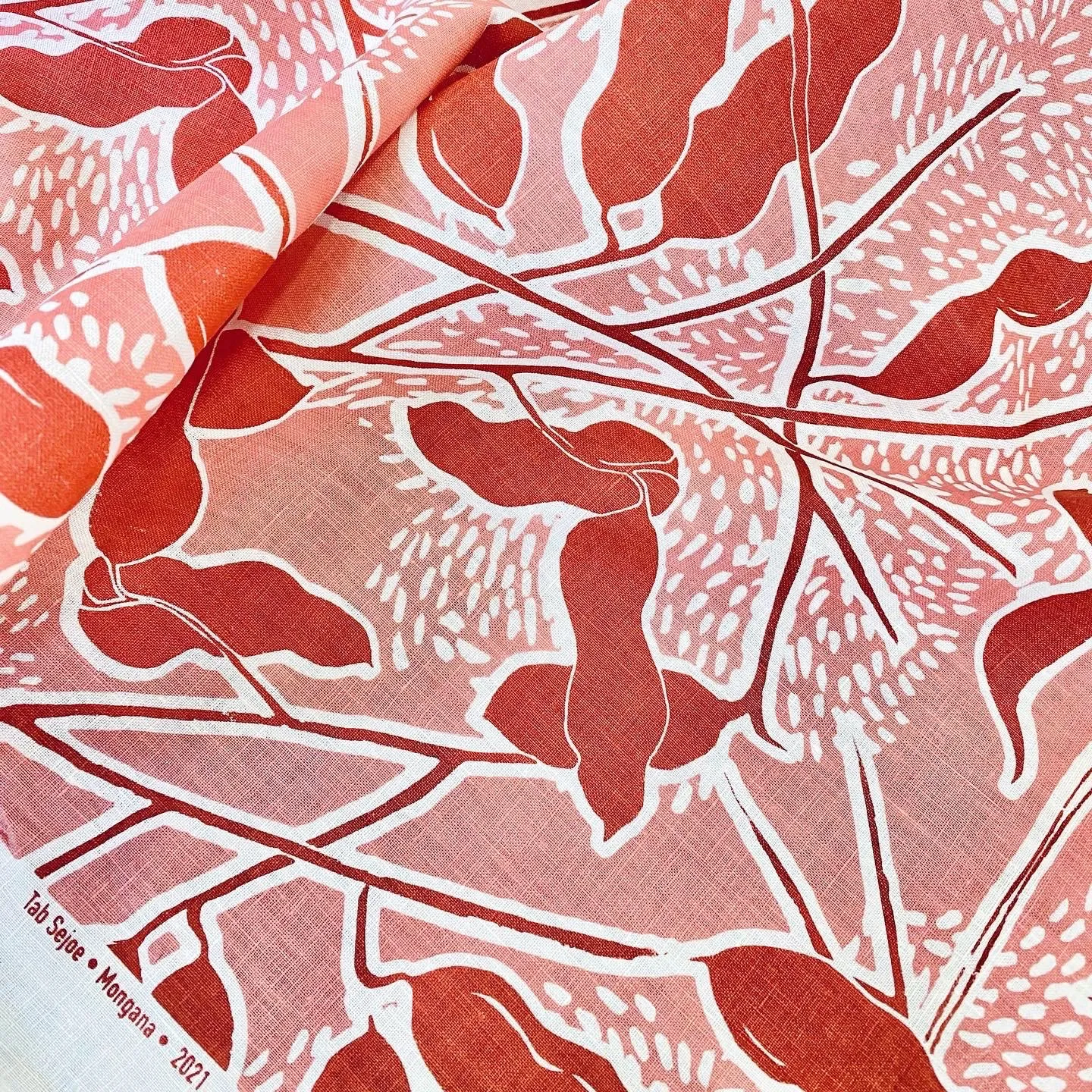 Mongana pods in rust on shell pink linen