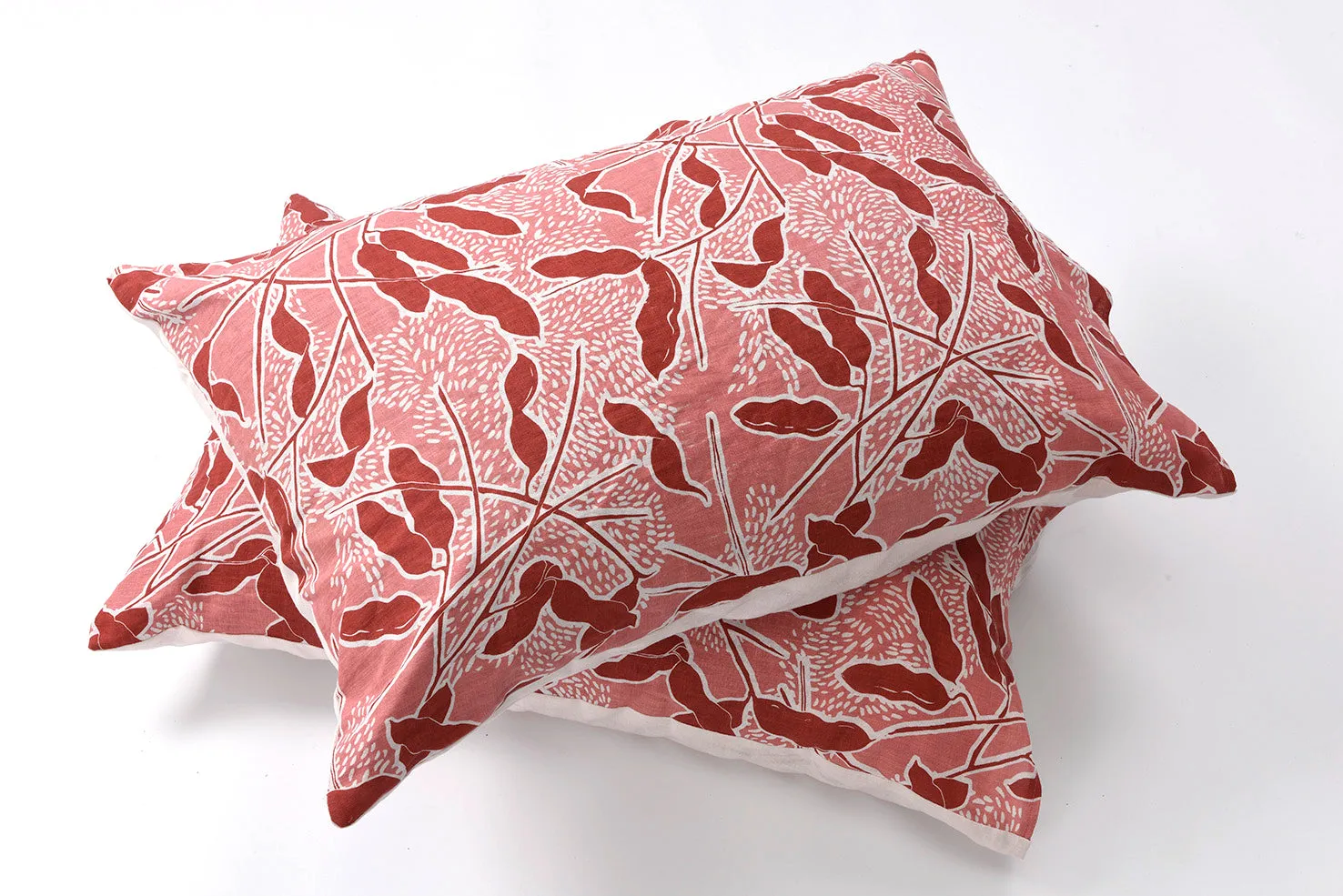 Mongana pods in rust on shell pink linen