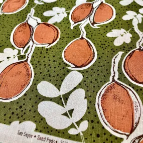 Seed pods in rust_olive on shell pink linen